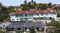 This photo released by Easy Solar shows a large solar panels installation on a rooftop of an office…