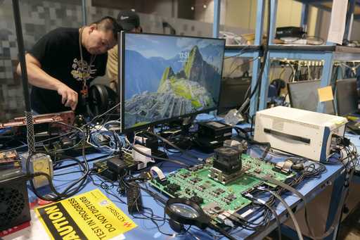 Employees work behind an evaluation board, foreground, in a lab at the d-Matrix office in Santa Cla…