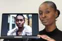 Fashion model Alexsandrah poses with a computer showing an AI generated image of her, in London, Fr…