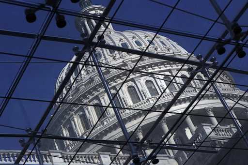 The Capitol dome on Capitol Hill is seen through a glass structure in Washington, on April 6, 2011