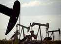 Pump jacks work in a field near Lovington, N.M., April 24, 2015. (AP Photo/Charlie Riedel, File)