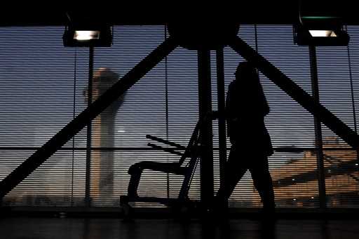 An airline employee transfers a wheelchair to her station at O'Hare International Airport in Chicag…