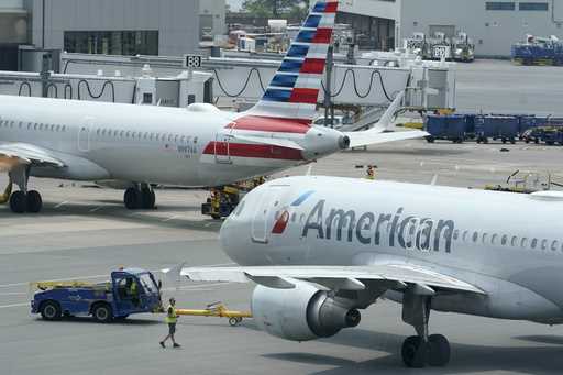 American Airlines passenger jets prepare for departure, July 21, 2021, near a terminal at Boston Lo…