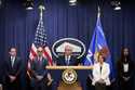 The Department of Justice seals is seen during a news conference at the DOJ office in Washington, M…