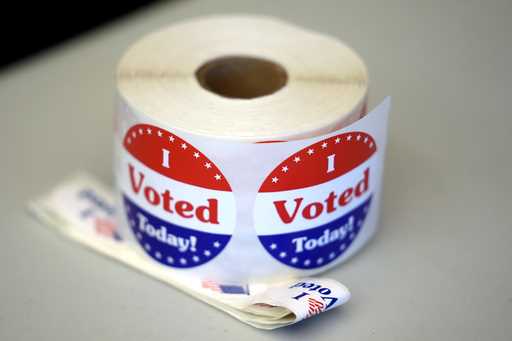 A spool of stickers rests on a table at a polling station during Massachusetts state primary voting…