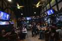 People watch TV screens showing a debate between Democratic presidential nominee Vice President Kam…