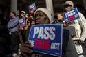 People gather outside of City Hall for a rally in support of the FARE Act ahead of a City Council m…