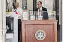 Apple executive Phil Schiller, left, goes through courthouse security in Oakland, Calif