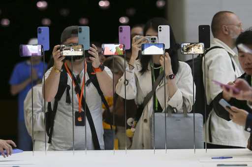 Attendees take a closer look at the Apple iPhone 16 during an announcement of new products at Apple…