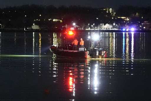 A boat works the scene near Ronald Reagan Washington National Airport, Thursday, January 30, 2025, …