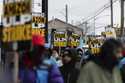 Amazon workers and members of the International Brotherhood of Teamsters picket in front of the Ama…