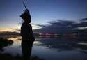 Robson Mura, of the Mura Indigenous community, watches the sunrise at the Moyray village in Autazes…