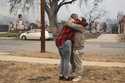 Lisa Diaz hugs a neighbor outside of their homes as the Eaton Fire sweeps through the area Wednesda…