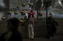 A beam of sunlight is cast on a woman as visitors take souvenir photos with the communist symbol of…