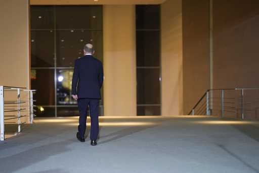 German Chancellor Olaf Scholz leaves after making a statement after a meeting with government leade…