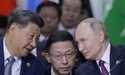 Chinese President Xi Jinping, left, and Russian President Vladimir Putin, right, speak during Outre…