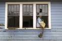 Ben Phillips scoops mud out a window of his house left in the wake of Hurricane Helene, Tuesday, Oc…