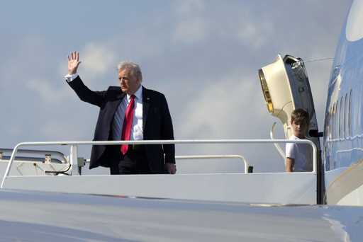 President Donald Trump, left, waves as he boards Air Force One with grandson Theodore, Ivanka Trump…