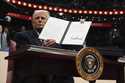 President Donald Trump signs an executive order as he attends an indoor Presidential Inauguration p…