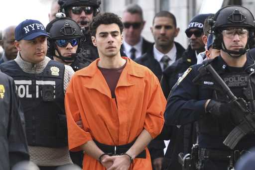 Luigi Mangione, a suspect in the fatal shooting of UnitedHealthcare CEO Brian Thompson, is escorted…