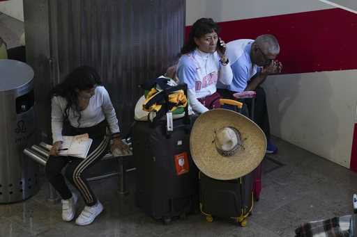 Passengers wait at Benito Juárez International Airport in Mexico City, Friday, July 19, 2024