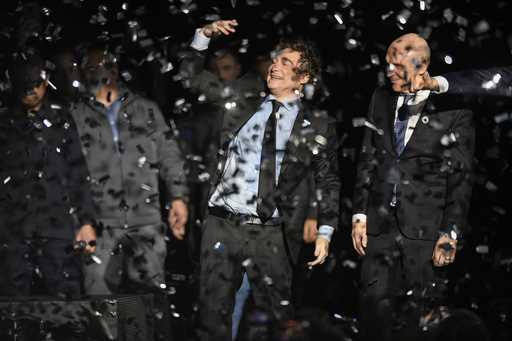 Argentine President Javier Milei, center, and National Deputy Jose Luis Espert celebrate at the end…