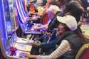 A gambler plays a slot machine while smoking at the Hard Rock casino in Atlantic City, N