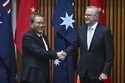 Chinese Premier Li Qiang, left, and Australia's Prime Minister Anthony Albanese shake hands during …