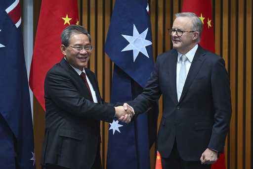 Chinese Premier Li Qiang, left, and Australia's Prime Minister Anthony Albanese shake hands during …