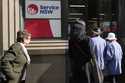 People walk in to a Services New South Wales office in Sydney, Tuesday, August 6, 2024