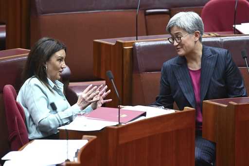 Senator Jacqui Lambie, left, gestures as she speaks to Australian Foreign Minister Penny Wong durin…