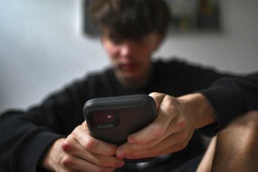 A teenager uses his mobile phone to access social media, Sydney, Wednesday, November 13, 2024