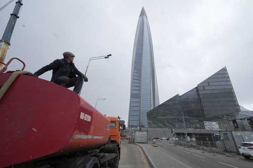 A worker sits on his water tank truck next to the business tower Lakhta Centre, the headquarters of…