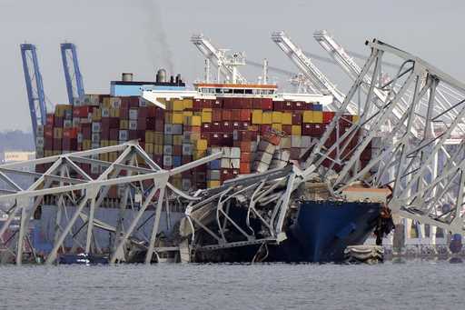 The cargo ship Dali is stuck under part of the structure of the Francis Scott Key Bridge after the …