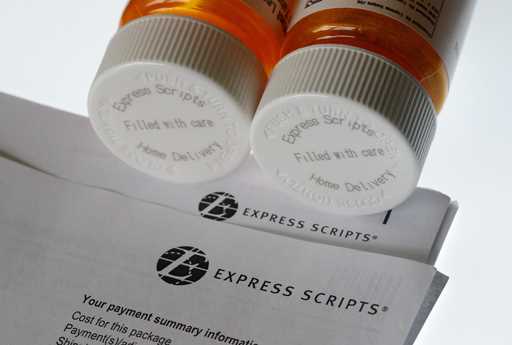 In this Tuesday, July 25, 2017, file photo, Express Scripts prescription medication bottles are arr…