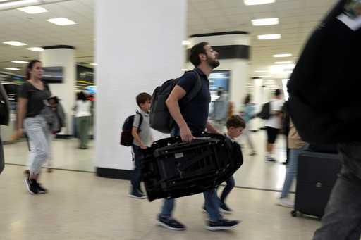 Travelers walk through the concourse at Miami International Airport on May 23, 2024, in Miami