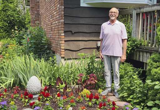 Jeff Kellert stands in his garden at his home in Albany, N
