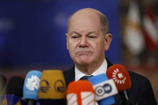 Germany's Chancellor Olaf Scholz speaks with the media as he arrives for an EU summit at the Europe…