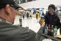 Jimmy Gross serves Jonathon Holdway some Third Space Marquette beer before an NCAA college basketba…