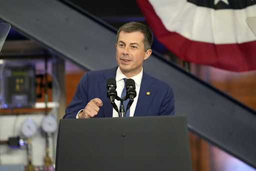 Transportation Secretary Pete Buttigieg speaks before President Joe Biden during a visit to the U