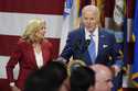 President Joe Biden speaks as first lady Jill Biden looks on at a Friendsgiving event with service …