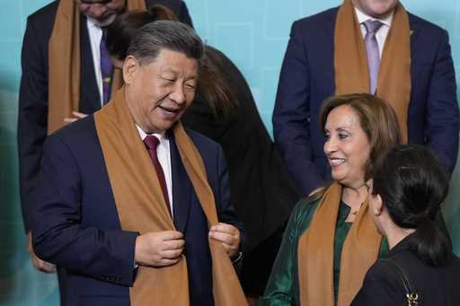 China's President Xi Jinping, left, speaks with Peru's President Dina Boluarte, right, as they and …