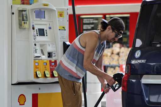 Oregon resident Patrick Coffin fills up his car at a gas station in Portland, Ore