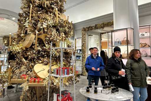 Shoppers pass a Christmas tree at the Bergdorf Goodman store on Sunday, November 24, 2024, in New Y…