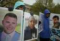 Protesters hold the photographs of victims, including Melvin Riffel, left, of the Ethiopian Airline…