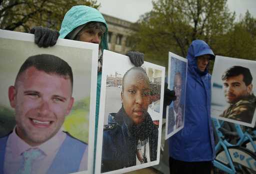 Protesters hold photographs of victims, including Melvin Riffel, left, of the 2019 Ethiopian Airlin…