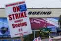 Boeing workers wave picket signs as they strike after union members voted to reject a contract offe…