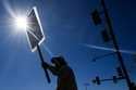 Boeing employee Som Dom, an electrician who has worked 17 years at Renton factory, holds a picket s…