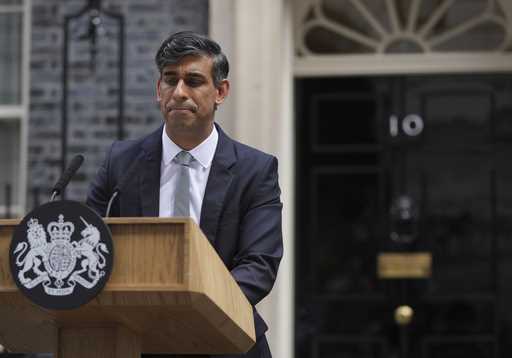 Britain's outgoing Conservative Party Prime Minister Rishi Sunak looks down as he makes a short spe…