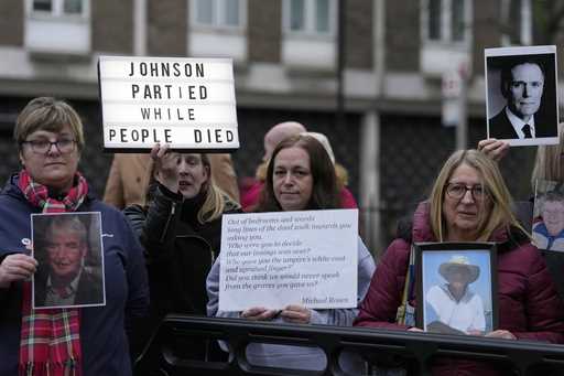 Protesters show pictures of COVID victims and placards outside Dorland House as Britain's former Pr…